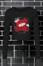 CocoMe Couture black long sleeve micro rib baby tee with a Pretty but a Problem graphic print on a brick background.