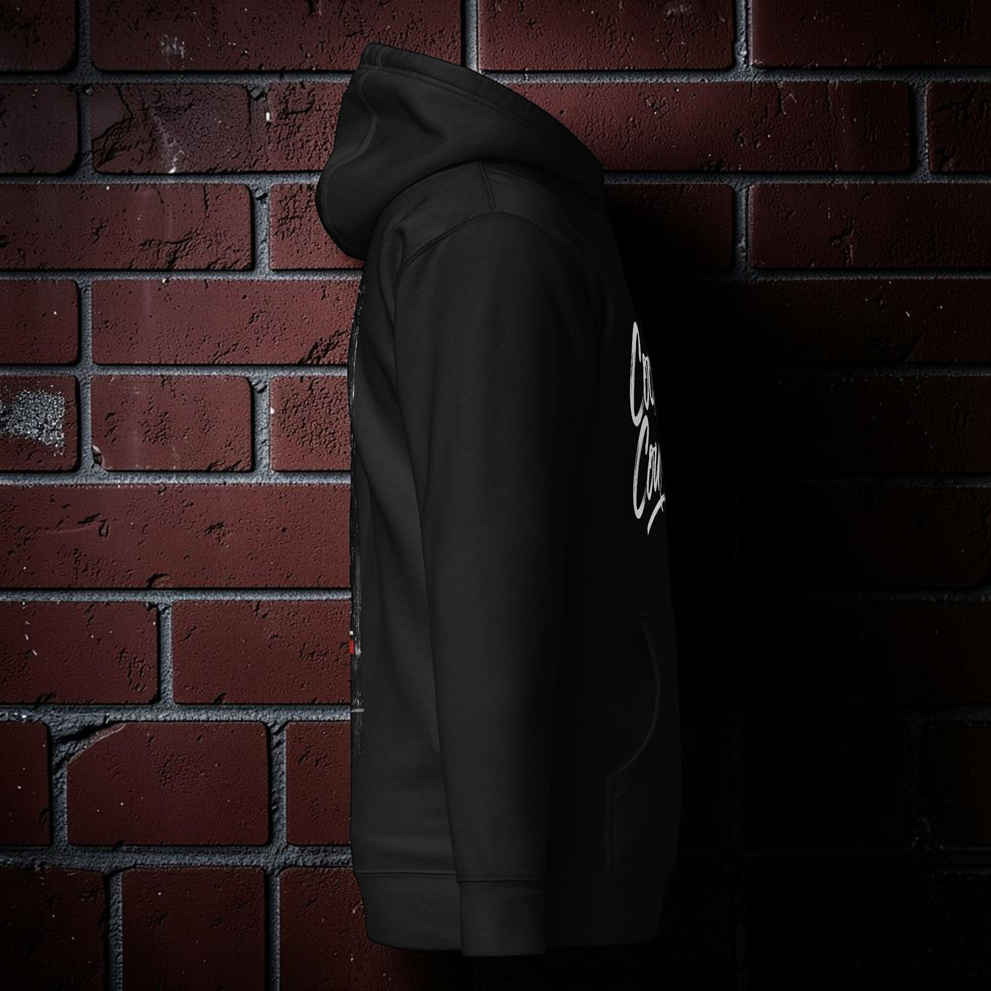 CocoMe Couture Own the Streets black premium hoodie with a 3-panel hood and kangaroo pocket against a brick wall