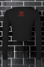 CocoMe Couture black long sleeve micro rib baby tee with red logo on the back against a black brick wall background