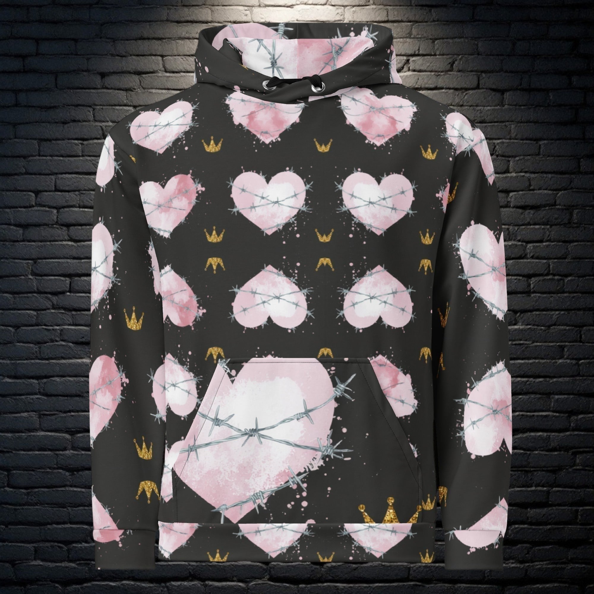 CocoMe Couture Heart of Thorns unisex hoodie with black background, pink heart print, barbed wire, and gold crowns.