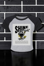 Women's Shine Bright Micro Rib Raglan Baby Tee – Cropped Fitted Stretch Shirt showing the bold Shine Bright graphic and soft micro rib texture