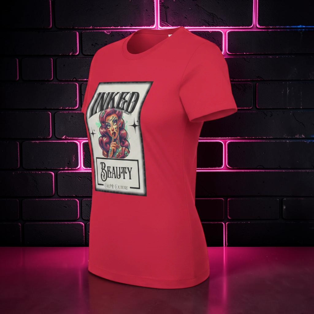 CocoMe Couture red crewneck t-shirt featuring an Inked Beauty graphic print, displayed against a dark brick wall.