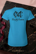 CocoMe Couture sapphire blue heavy cotton women's tee with black logo graphic on back, displayed on marble surface.