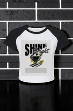 Women's Shine Bright Micro Rib Raglan Baby Tee – Cropped Fitted Stretch Shirt with bold graphic, soft micro rib fabric, cropped fit, and sporty raglan sleeves