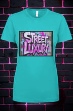 CocoMe Couture turquoise crewneck t-shirt featuring a bold Street Luxury graffiti graphic print on the chest.