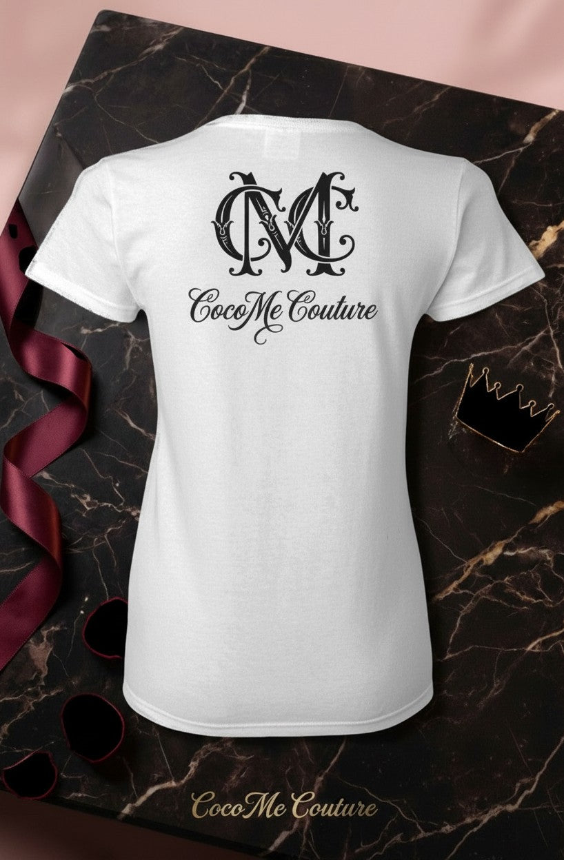 CocoMe Couture white heavy cotton tee with black logo print on the back, displayed on a dark marble surface.