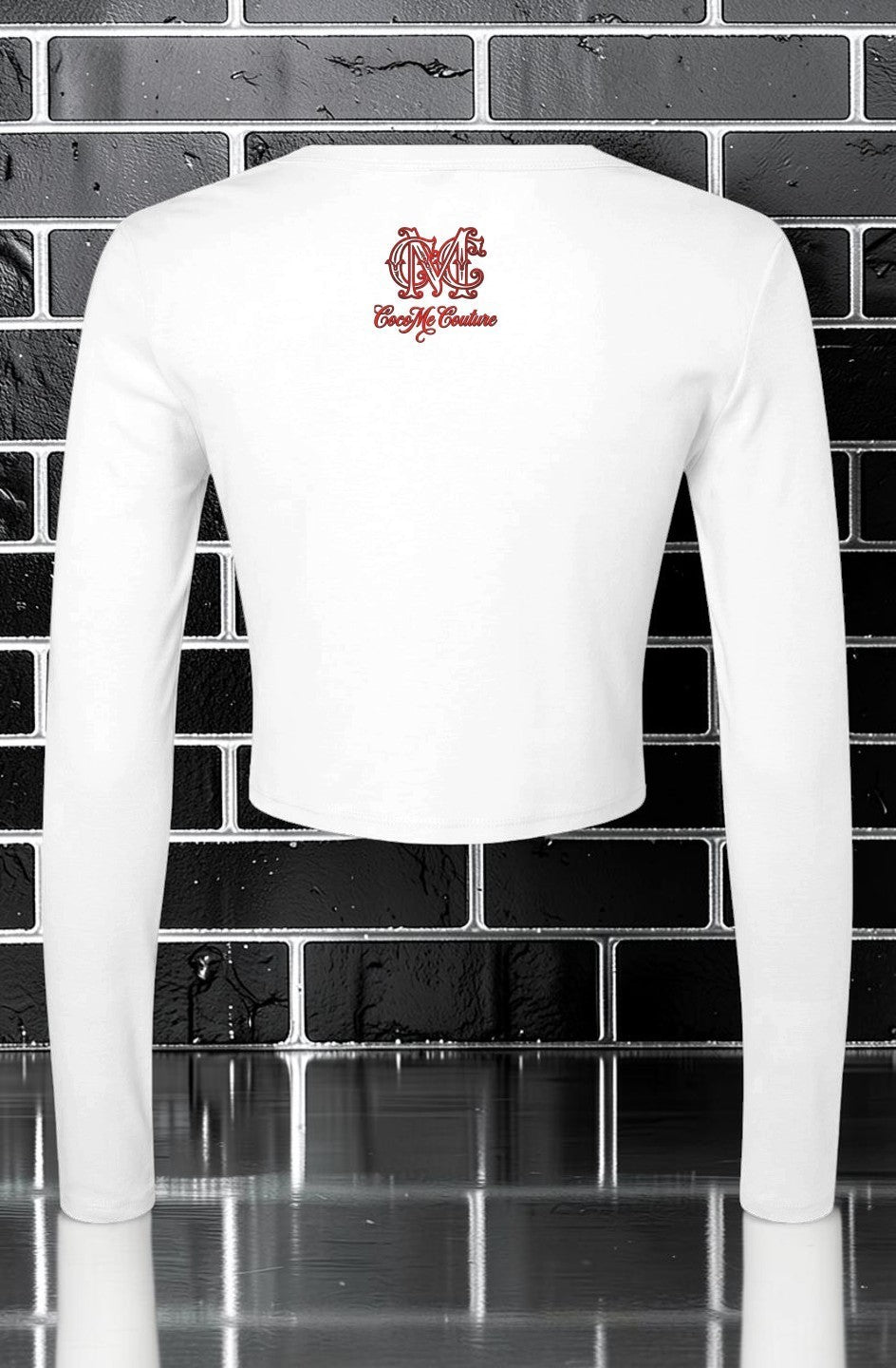 CocoMe Couture white micro rib long sleeve baby tee with back logo graphic against a black brick wall background