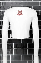 CocoMe Couture white micro rib long sleeve baby tee with back logo graphic against a black brick wall background